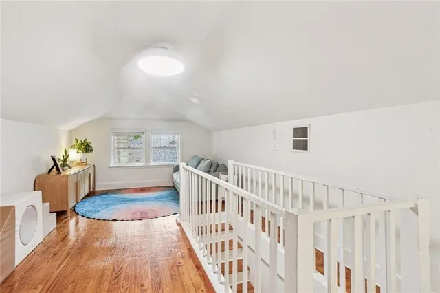 a view of a livingroom with wooden floor and furniture
