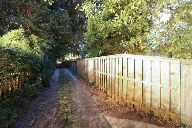 a view of a pathway with a garden