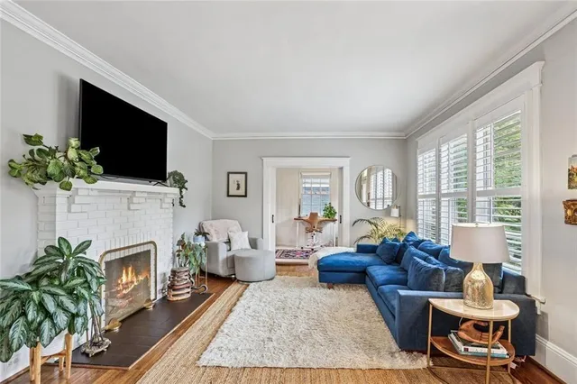 a living room with furniture a flat screen tv and a fireplace