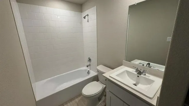 a bathroom with a sink toilet and a mirror