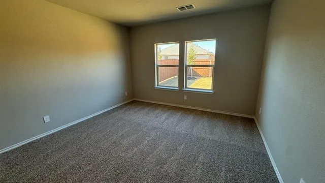 a large kitchen with stainless steel appliances a large counter top a stove a sink and a refrigerator