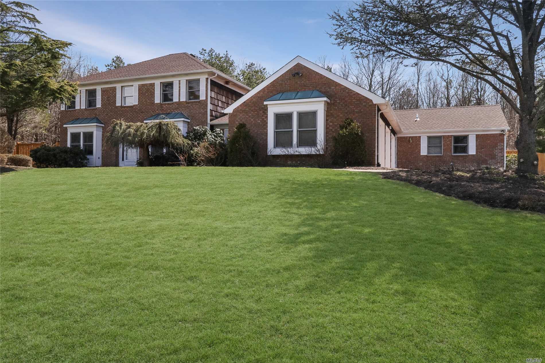 67-69 Timber Ridge Drive Commack, NY 11725 - Photo 1 of 1 a front view of a house with a garden