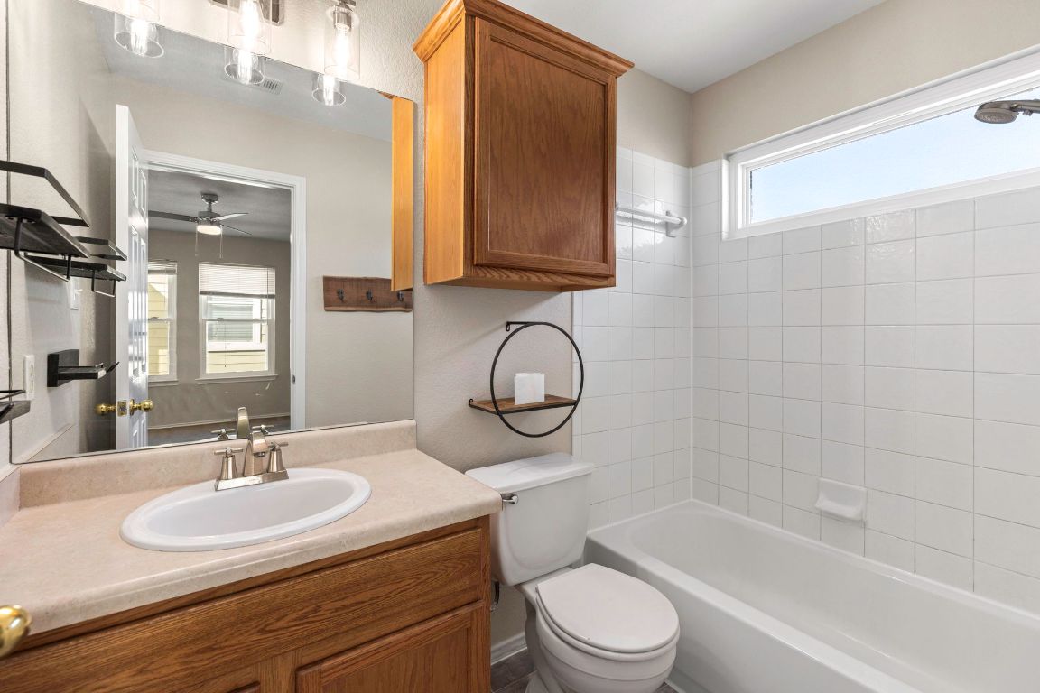 284 Michaelis Road Kyle, TX 78640 - Photo 12 of 20 a bathroom with a sink a toilet and a bathtub