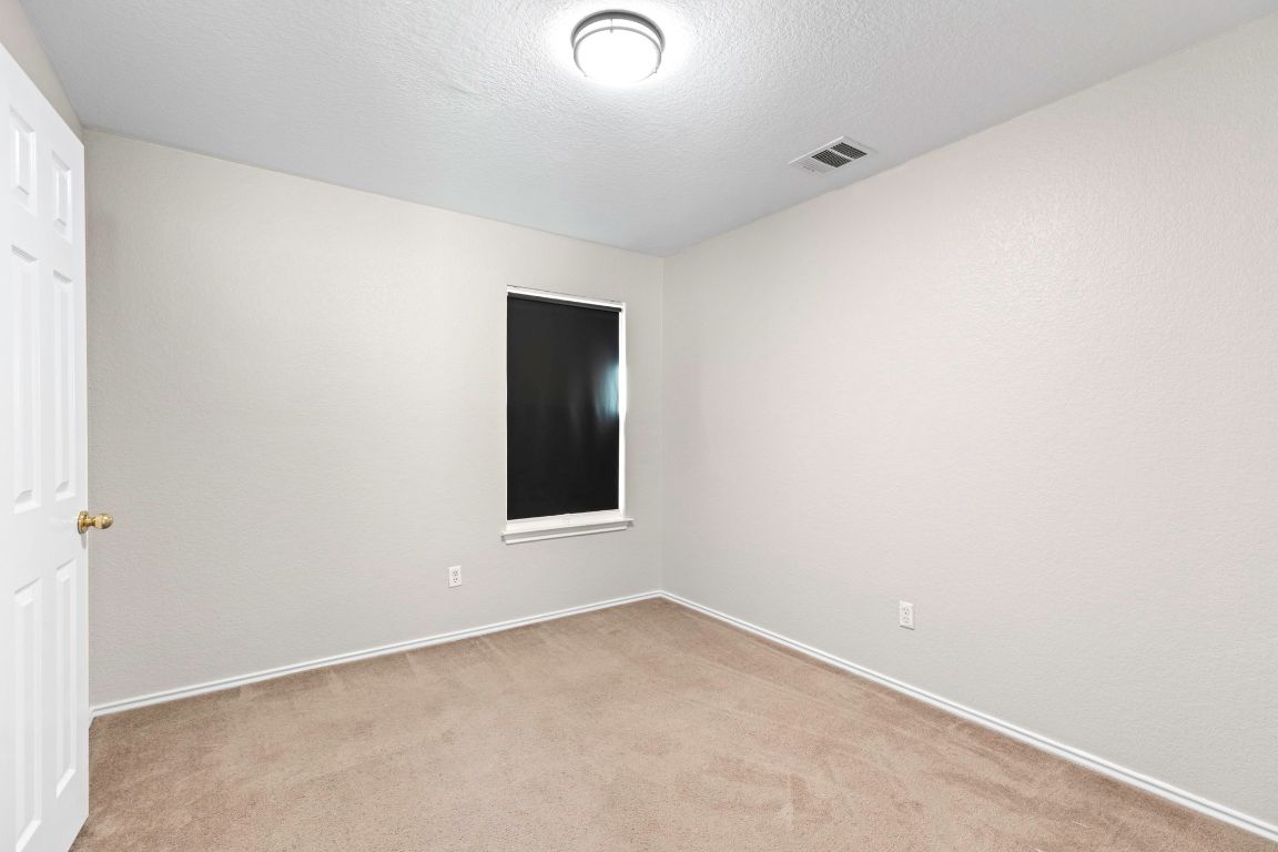 284 Michaelis Road Kyle, TX 78640 - Photo 13 of 20 an empty room with a window
