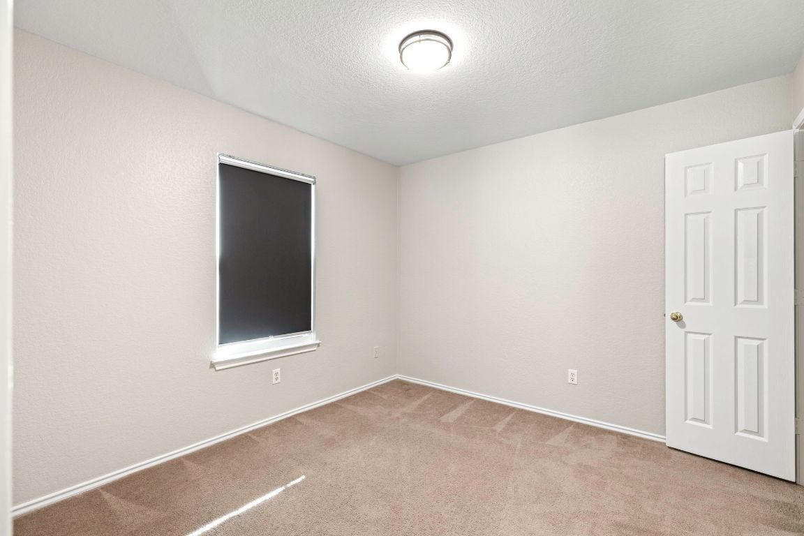 284 Michaelis Road Kyle, TX 78640 - Photo 14 of 20 an empty room with a window