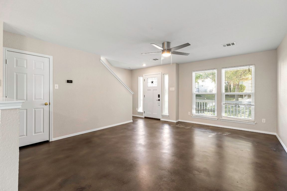 284 Michaelis Road Kyle, TX 78640 - Photo 3 of 20 an empty room with wooden floor and windows