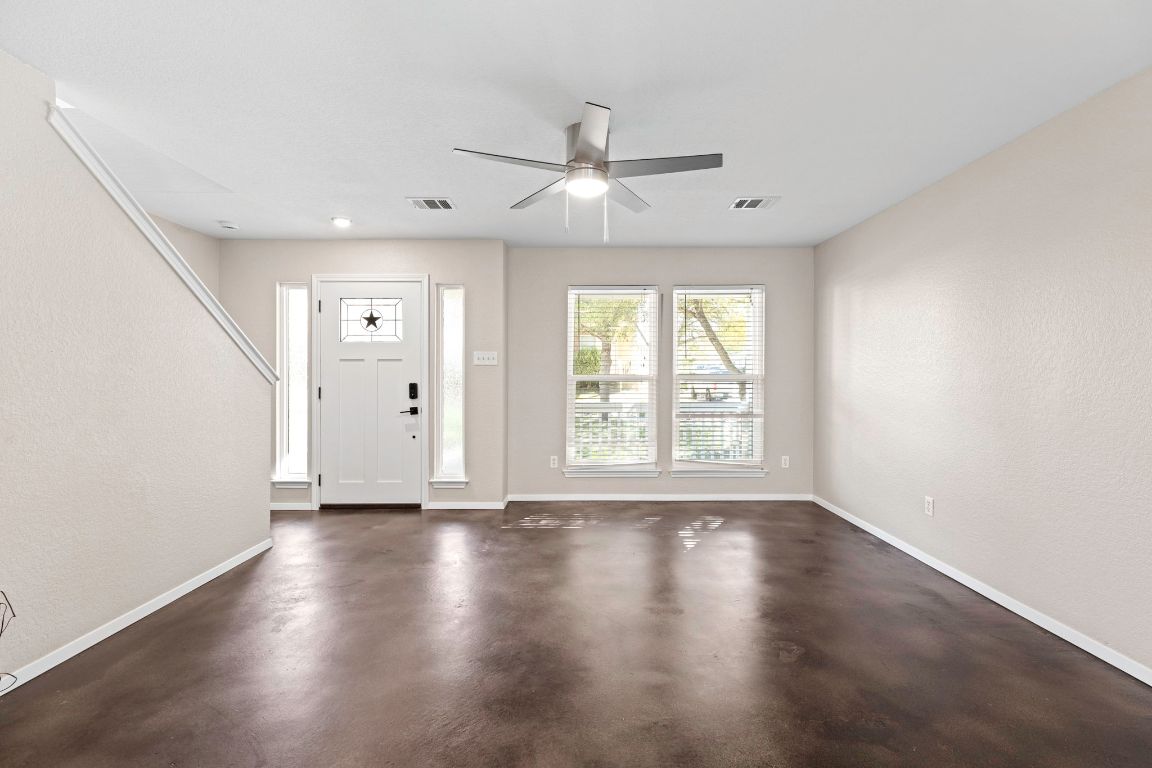 284 Michaelis Road Kyle, TX 78640 - Photo 4 of 20 a view of an empty room with wooden floor and a window