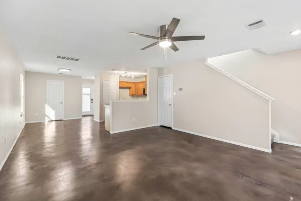 a view of a livingroom with a ceiling fan and wooden floor