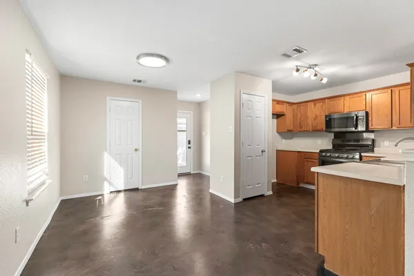 a view of a kitchen with a sink a refrigerator and window