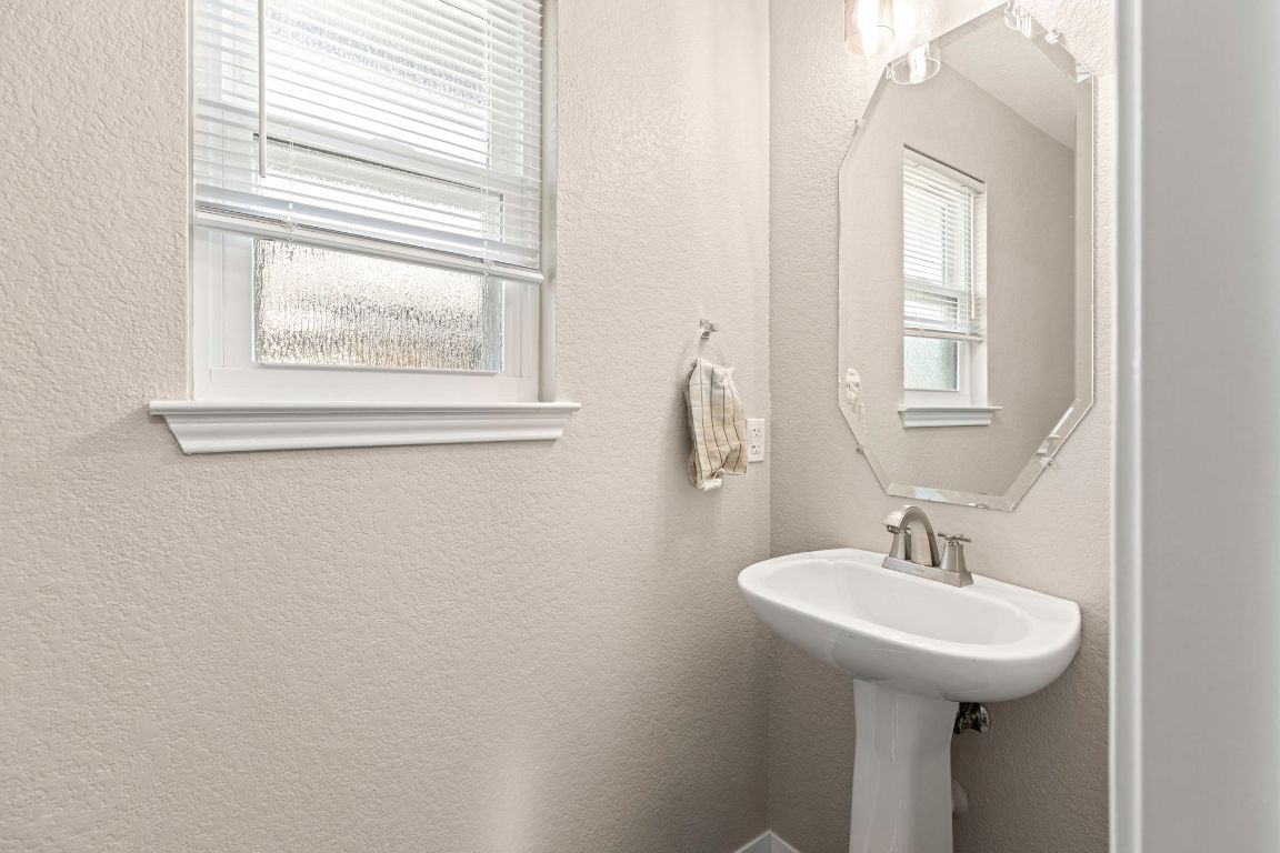 284 Michaelis Road Kyle, TX 78640 - Photo 10 of 20 a bathroom with a sink a mirror and a window