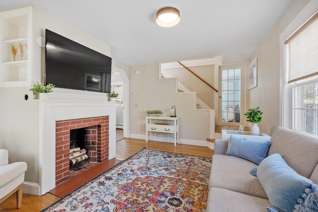 25 Naples Road Melrose, MA 02176 - Photo 5 of 36 a living room with furniture and a fireplace