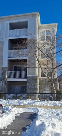 a view of a livingroom with furniture and floor to ceiling window