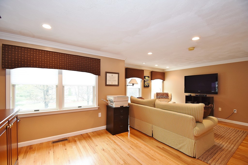 97 Hawthorne Village Road, Unit 97 Nashua, NH 03062 - Photo 13 of 30 a living room with furniture and a flat screen tv