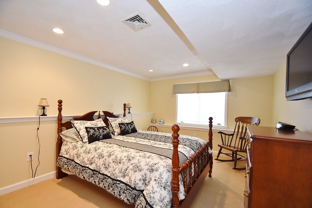 97 Hawthorne Village Road, Unit 97 Nashua, NH 03062 - Photo 23 of 30 a bedroom with two beds and a flat screen tv