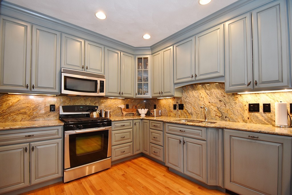 97 Hawthorne Village Road, Unit 97 Nashua, NH 03062 - Photo 3 of 30 a kitchen with stainless steel appliances granite countertop a sink a stove and cabinets
