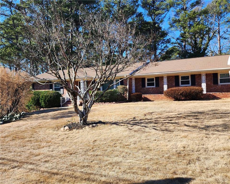 3404 Spring Valley Road Decatur, GA 30032 - Photo 1 of 1 a tree in front of a white house