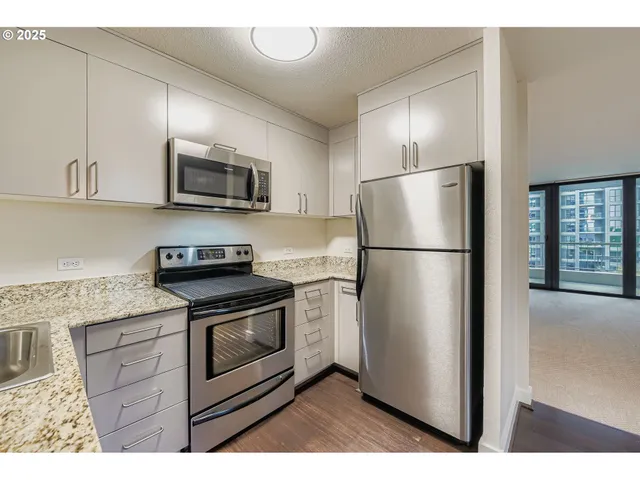 a kitchen with stainless steel appliances a refrigerator and a stove top oven