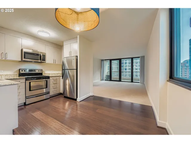 a bedroom with furniture and a large window