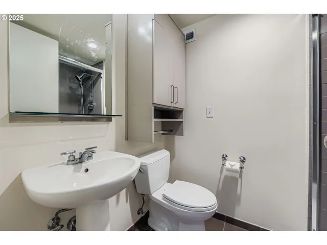 a view of a room with wooden floor and windows
