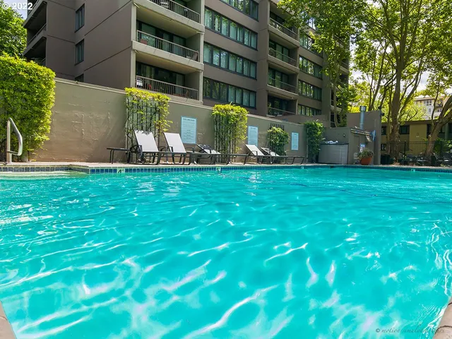 a view of a chair and table in backyard of the house