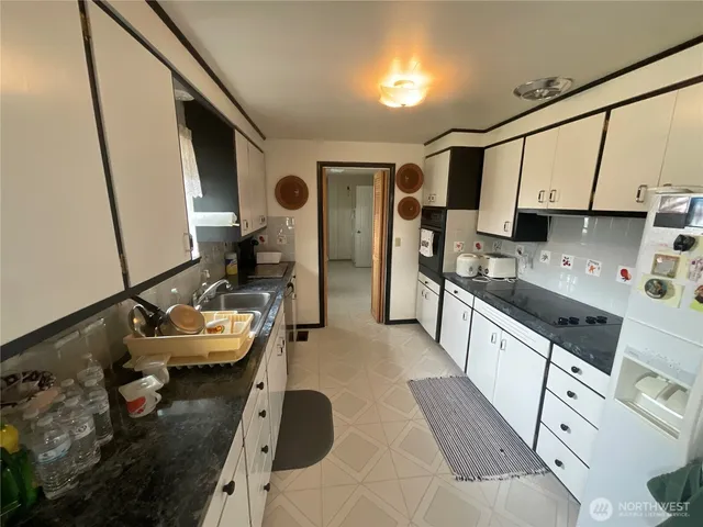 a kitchen with sink stove and cabinets