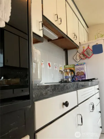 a kitchen with stainless steel appliances granite countertop a sink and cabinets