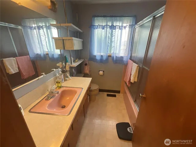 a bathroom with a sink and mirror