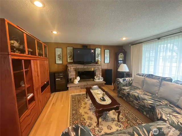 a living room with furniture fireplace and a flat screen tv