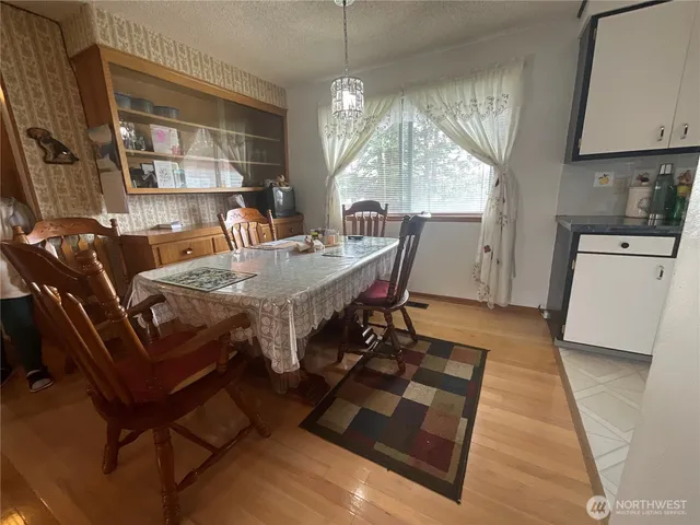 a view of a dining room with furniture window and wooden floor
