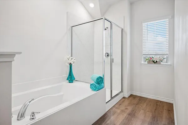 a bathroom with a bathtub and a shower