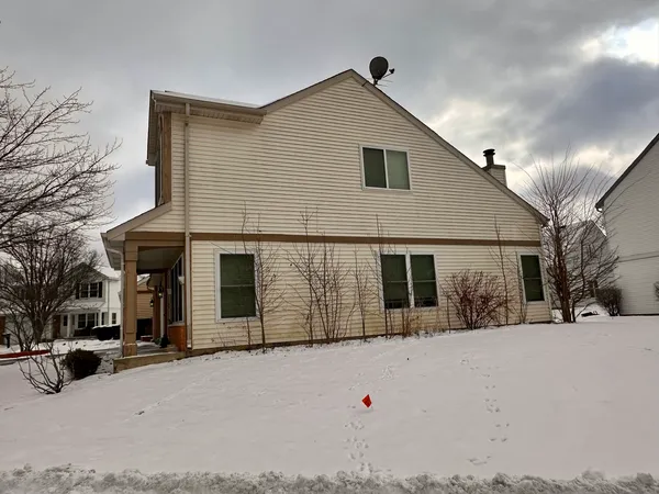 a view of a house with snow on the road