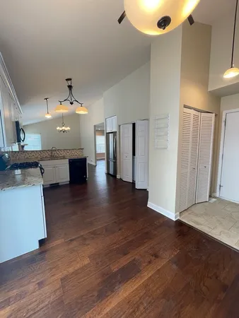 a view of kitchen and hall with wooden floor