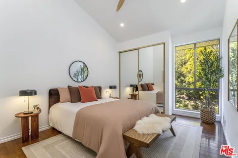 a bedroom with bed and a large window