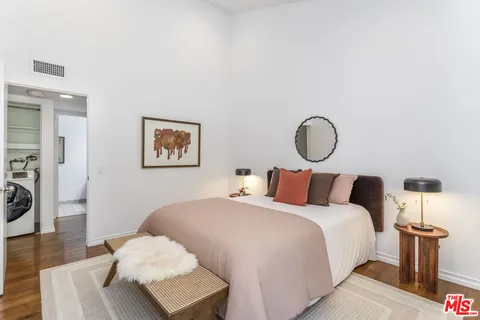 a bedroom with bed and a night stand