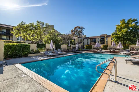 a view of a swimming pool and lounge chairs