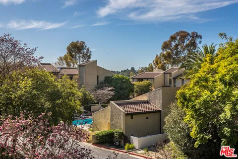 a view of a house with a yard and garden