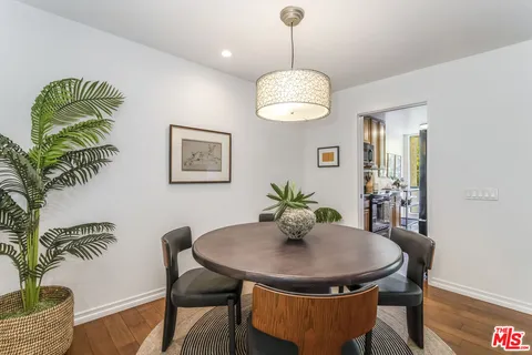 a view of a dining room with a table and chairs
