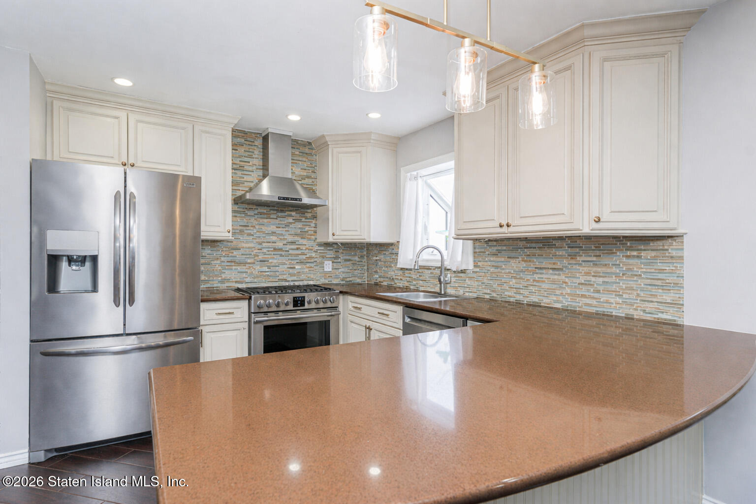 631 Travis Avenue Staten Island, NY 10314 - Photo 19 of 75 a kitchen with stainless steel appliances granite countertop a refrigerator a stove and a sink with wooden floors