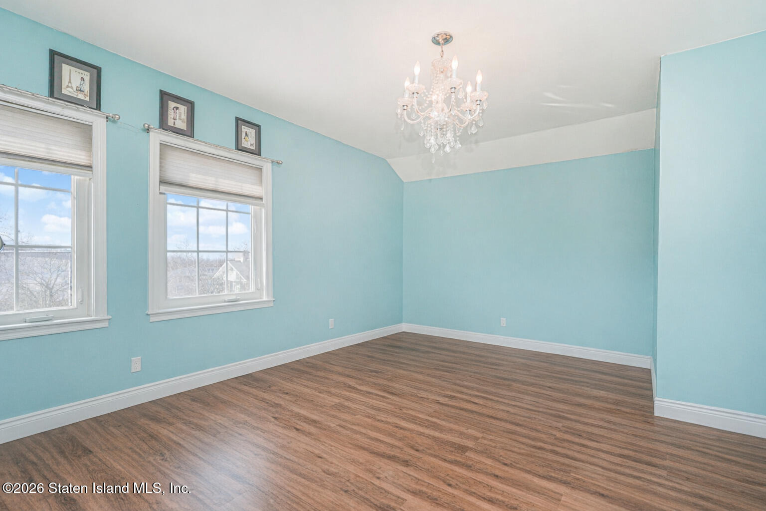 631 Travis Avenue Staten Island, NY 10314 - Photo 44 of 75 a view of an empty room with wooden floor and a window
