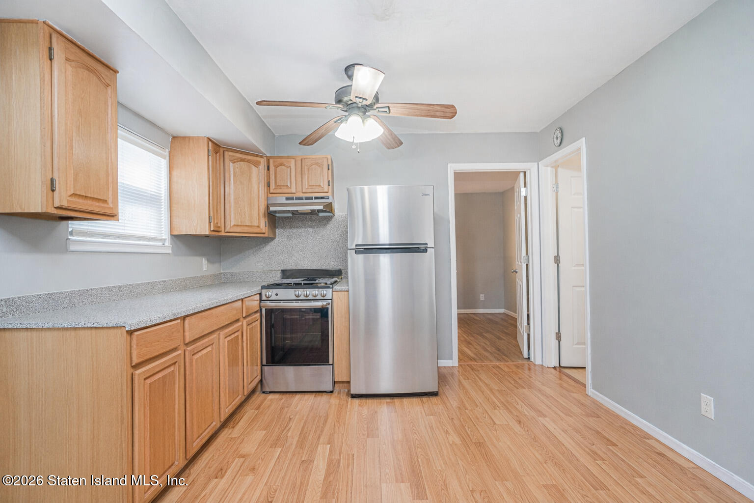 631 Travis Avenue Staten Island, NY 10314 - Photo 60 of 75 a kitchen with stainless steel appliances granite countertop a refrigerator a sink dishwasher a stove and white countertops with wooden floor