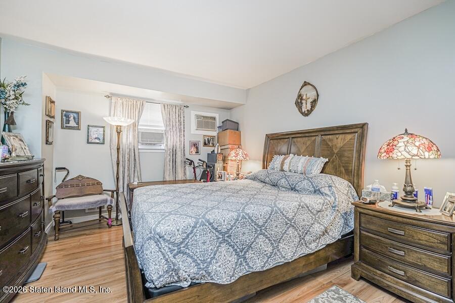 631 Travis Avenue Staten Island, NY 10314 - Photo 65 of 75 a bedroom with a bed and a lamp on dresser