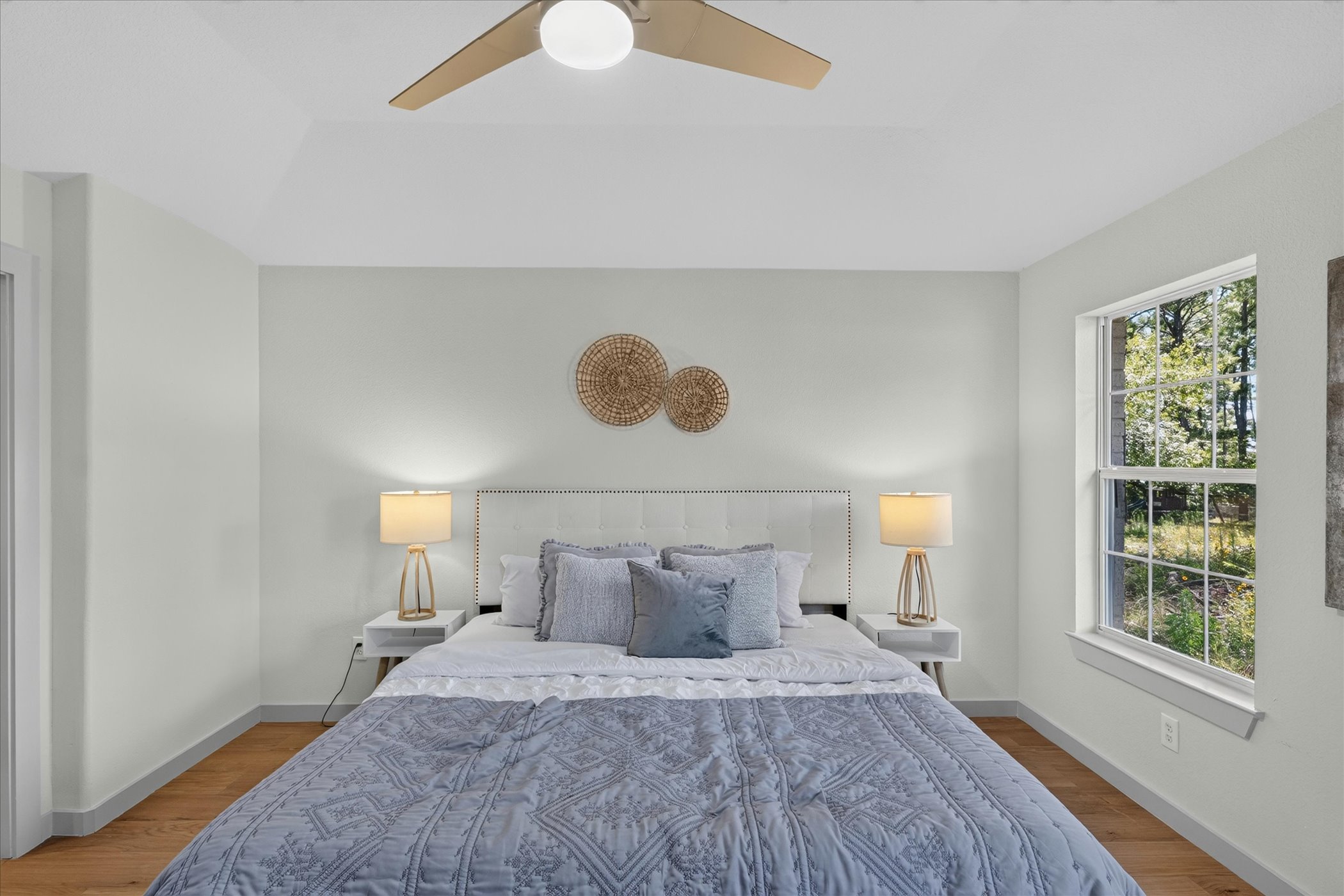 258 Pine View Loop Bastrop, TX 78602 - Photo 27 of 40 A tranquil bedroom retreat features soaring vaulted ceilings and rich hardwood flooring.