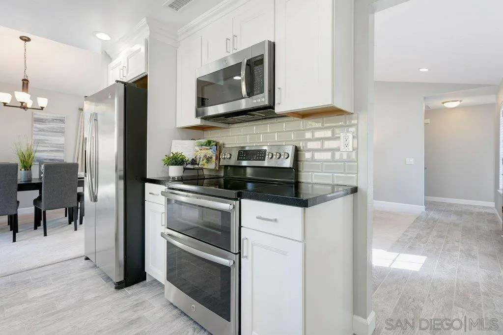 2725 Glasgow Drive Carlsbad, CA 92010 - Photo 12 of 29 a kitchen with stainless steel appliances granite countertop a stove microwave and refrigerator