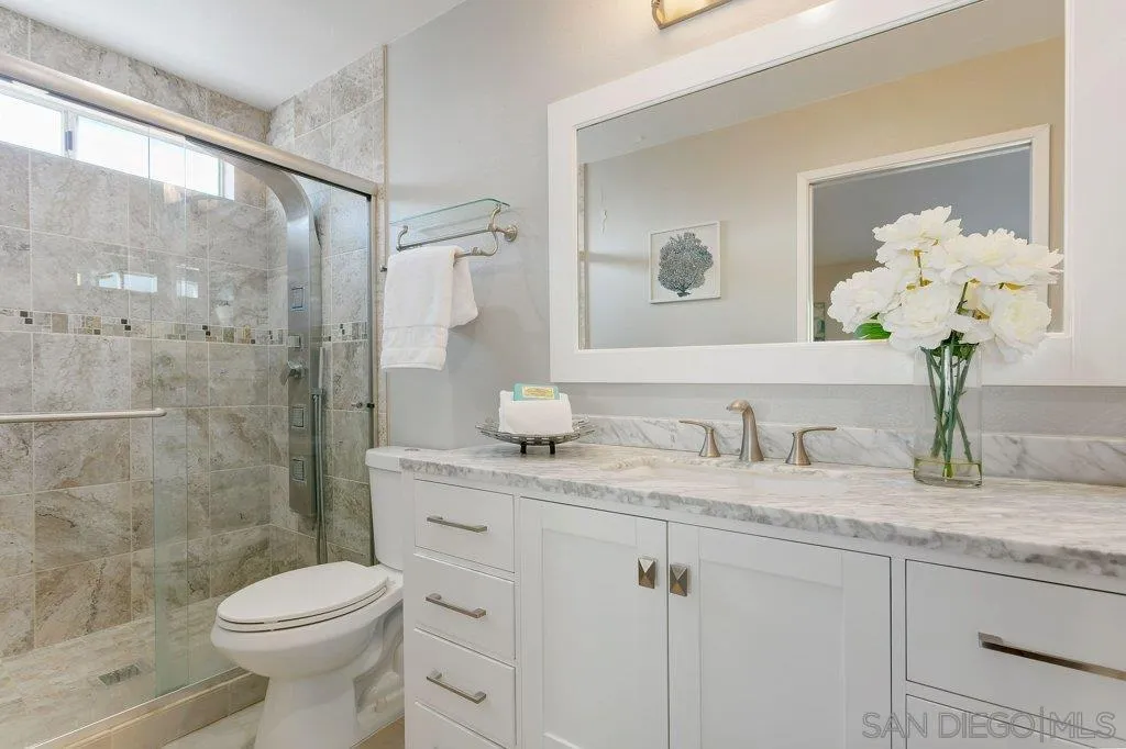 2725 Glasgow Drive Carlsbad, CA 92010 - Photo 15 of 29 a bathroom with a granite countertop toilet sink and shower