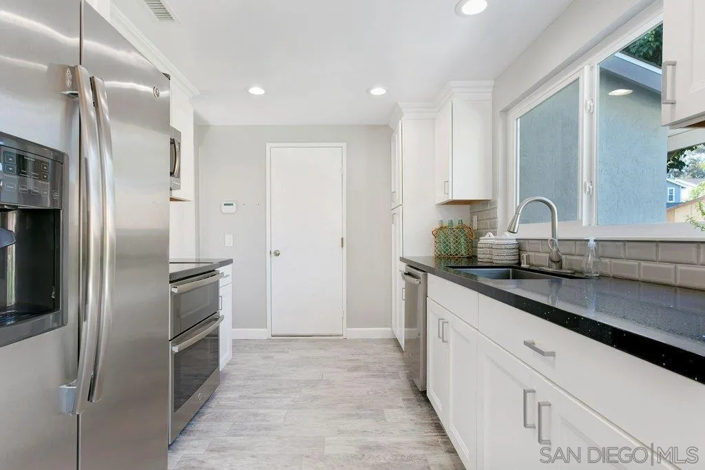 2725 Glasgow Drive Carlsbad, CA 92010 - Photo 10 of 29 a kitchen with stainless steel appliances granite countertop a refrigerator and a sink