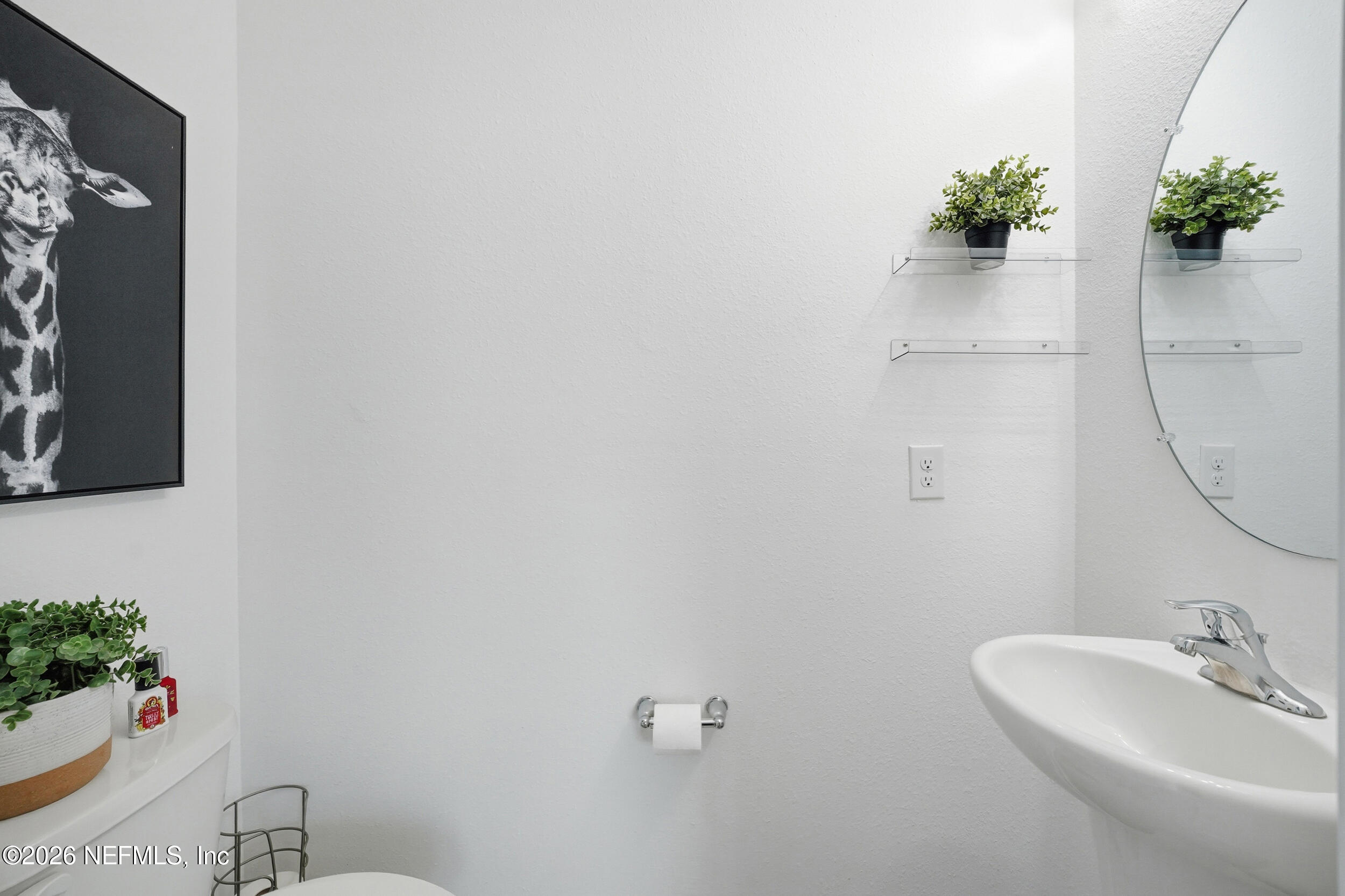 8323 Asteroid Street Jacksonville, FL 32256 - Photo 11 of 27 a bathroom with a sink and mirror