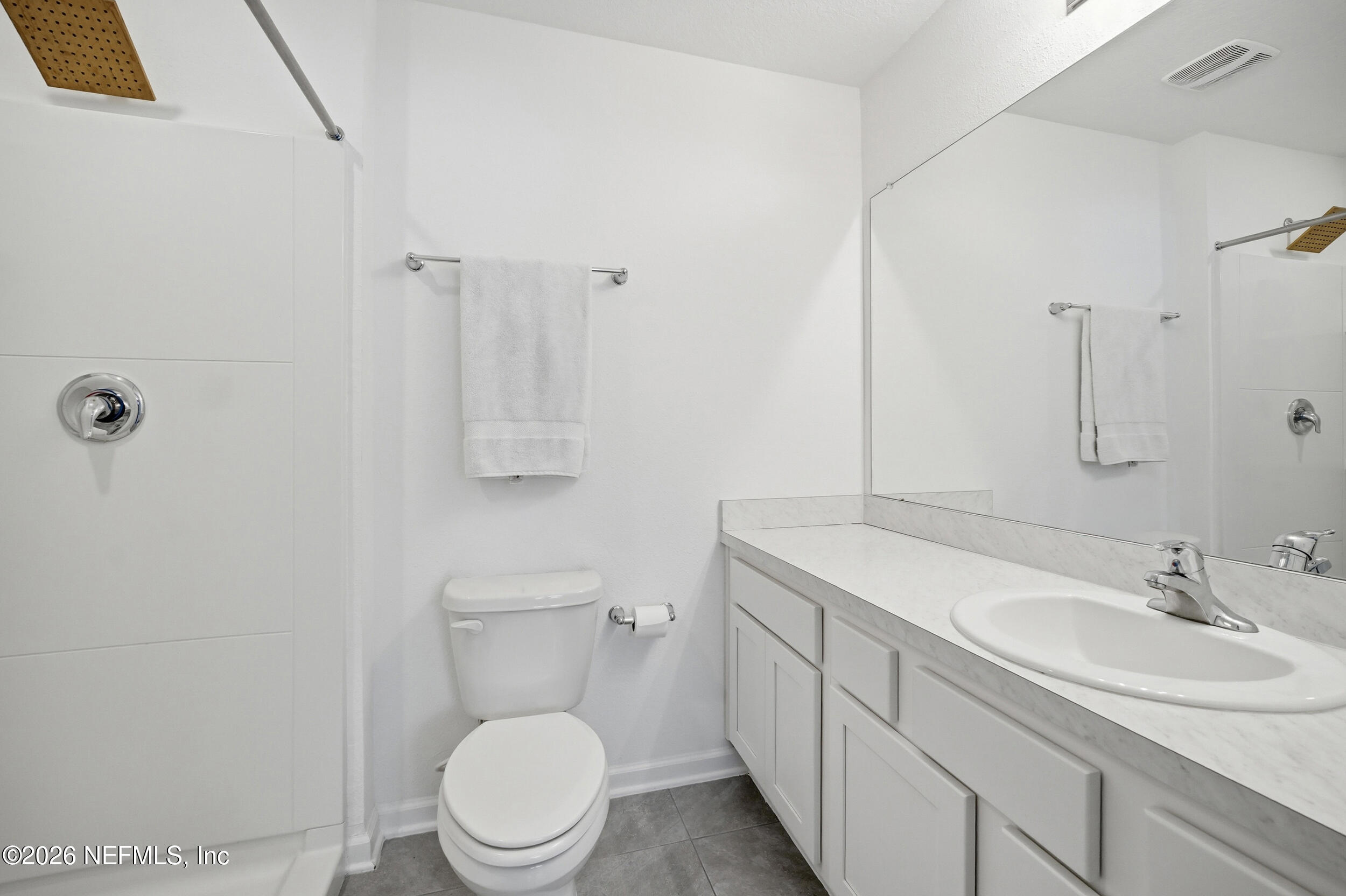 8323 Asteroid Street Jacksonville, FL 32256 - Photo 15 of 27 a bathroom with a toilet sink and mirror