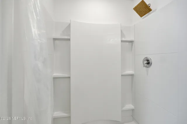 a bathroom with a toilet and shower