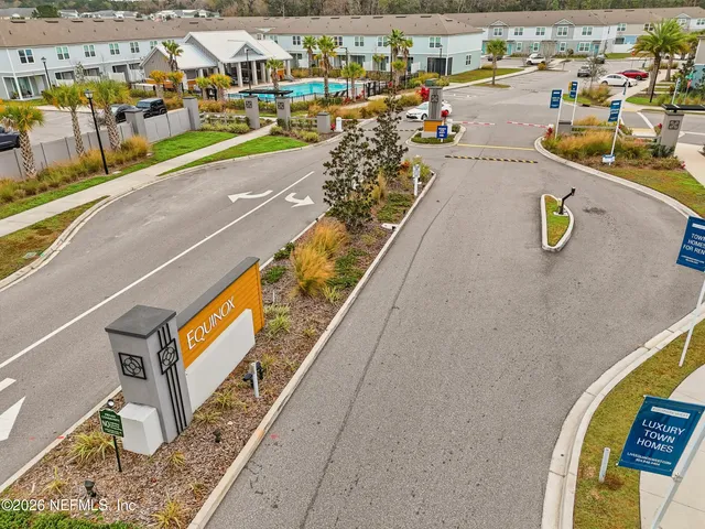 a view of a swimming pool with a yard and plants