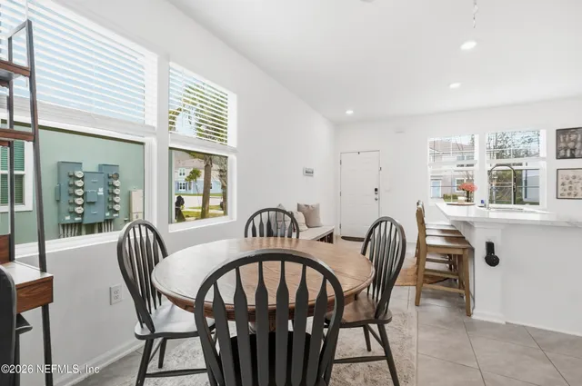 a view of a dining room with furniture and window